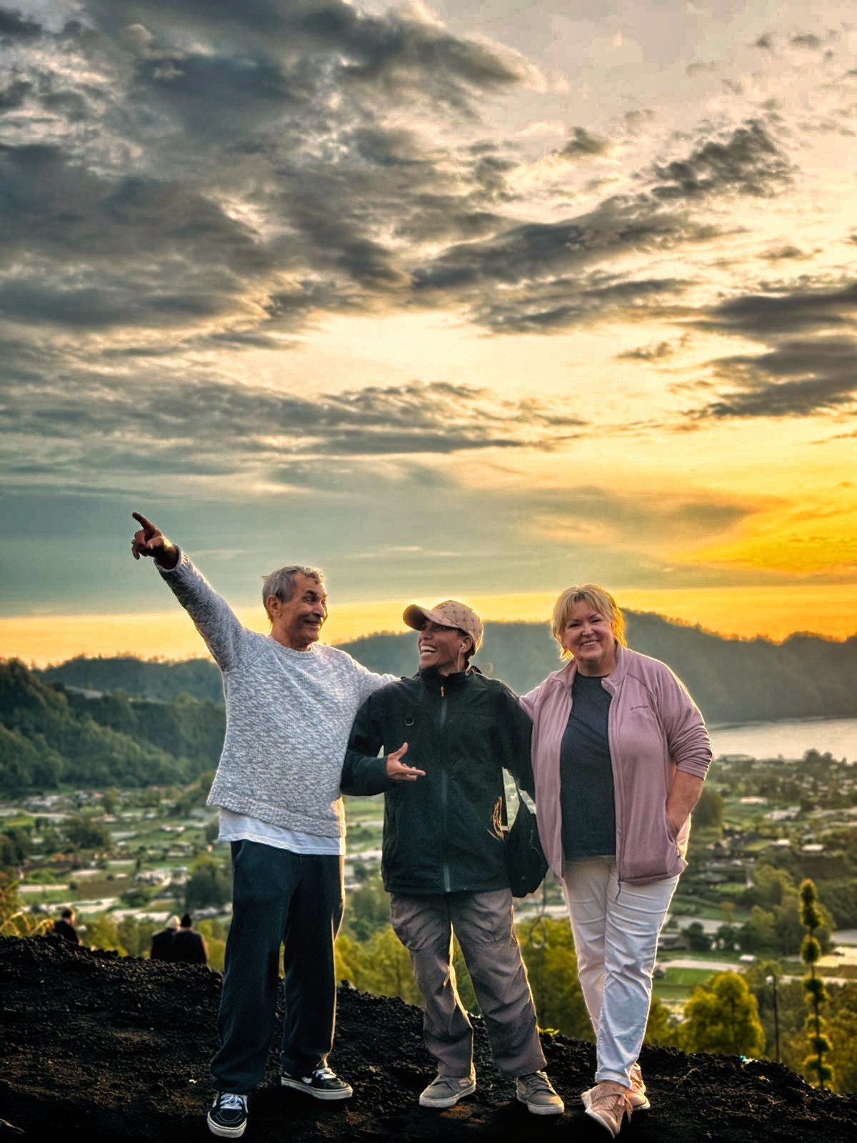 Guide and guests at sunrise above Lake Batur